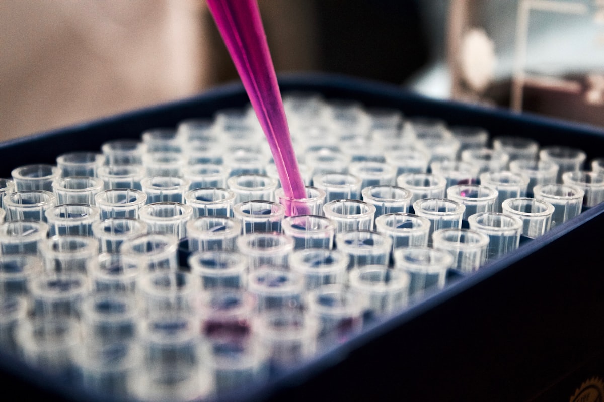 Laboratory pipette and sample tubes representing scientific research compute.